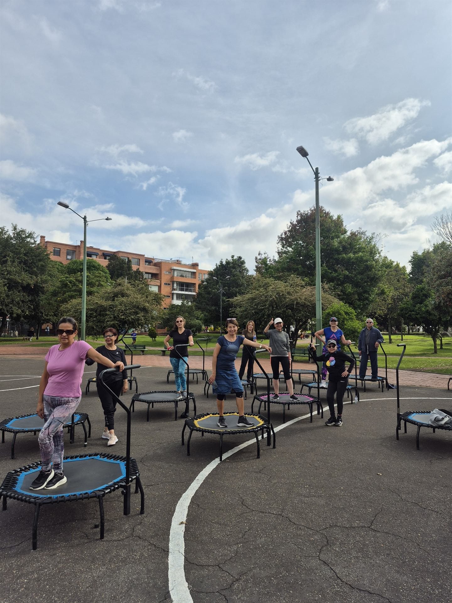Mujeres saltando en trampolín durante clase al aire libre